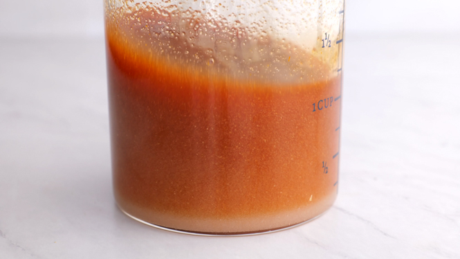 sweet and sour sauce in clear measuring cup